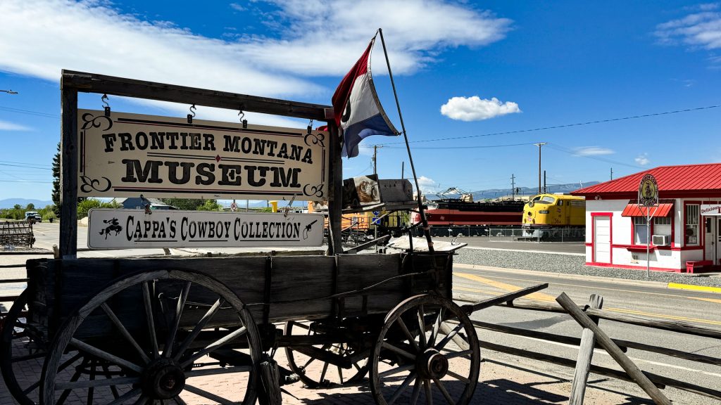 Museum sign on an old wagon along the highway in Deer Lodge, MT