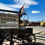 Museum sign on an old wagon along the highway in Deer Lodge, MT