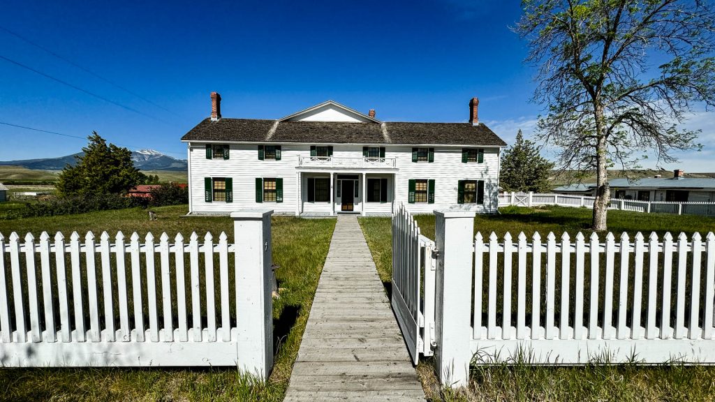 historic white building with a white picket fence